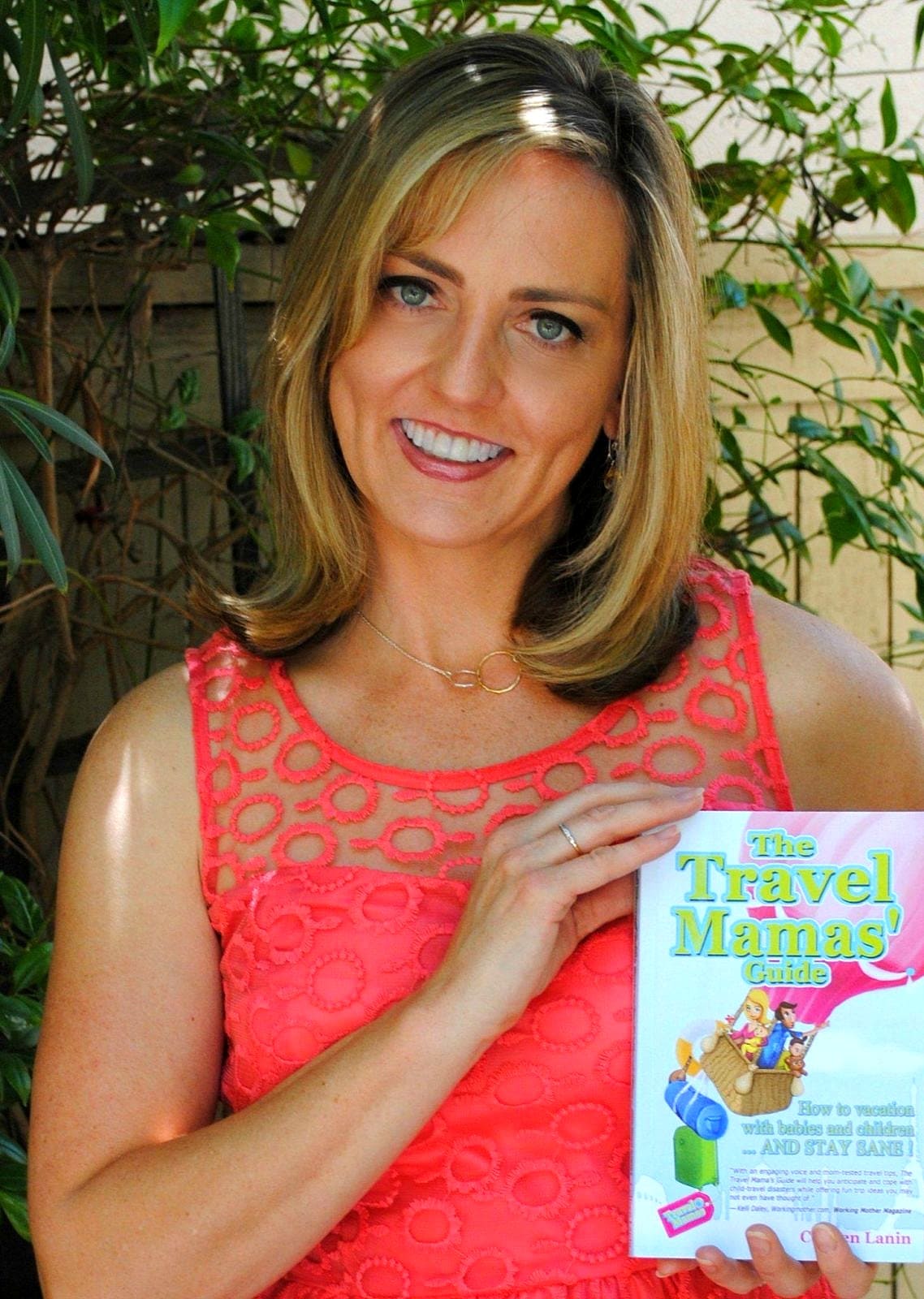 Colleen Lanin with her book, The Travel Mamas' Guide