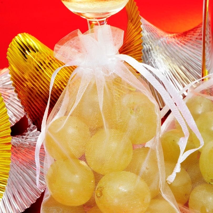 At midnight, revelers eat 12 grapes at the stroke of midnight in Spain for good luck in the New Year