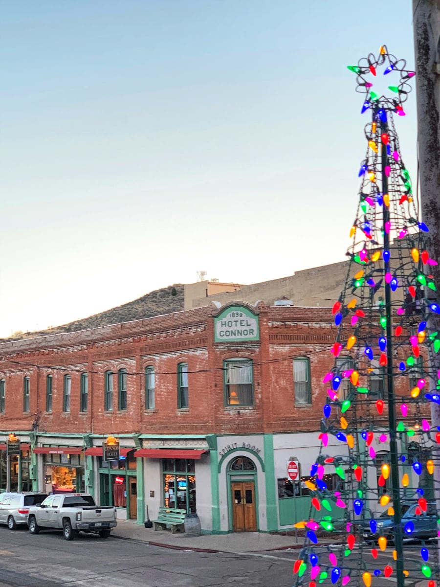 The Connor Hotel with Laura Williams Park holiday lights in the foreground in Jerome, AZ 