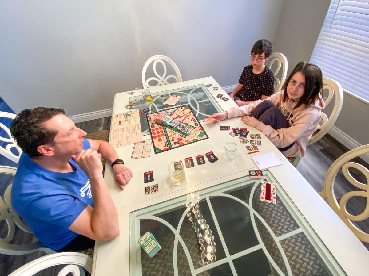 Family playing Escape from Iron Gate board game