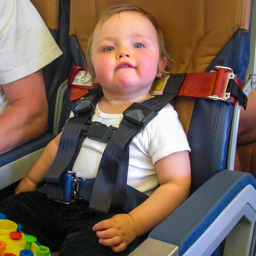 Toddler traveling on airplane with CARES harness