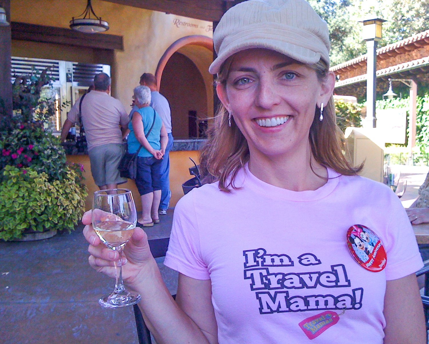 The Travel Mama wearing anniversary pin at Disney California Adventure Park during a Disneyland romantic getaway
