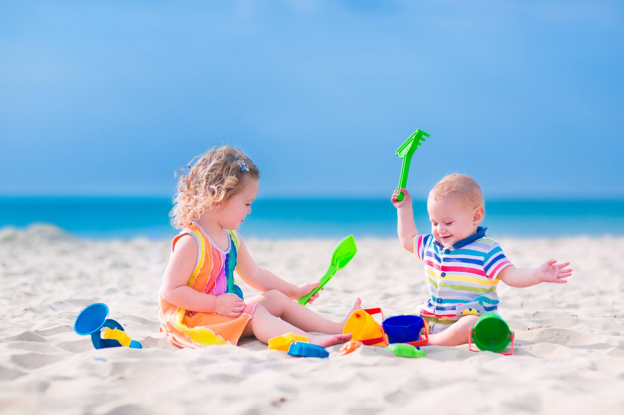 Baby and toddler on beach