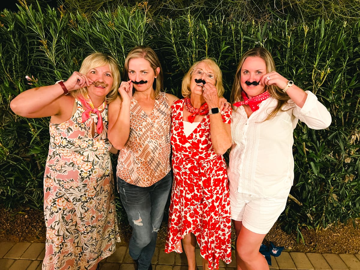 Backyard party guests wearing mustaches