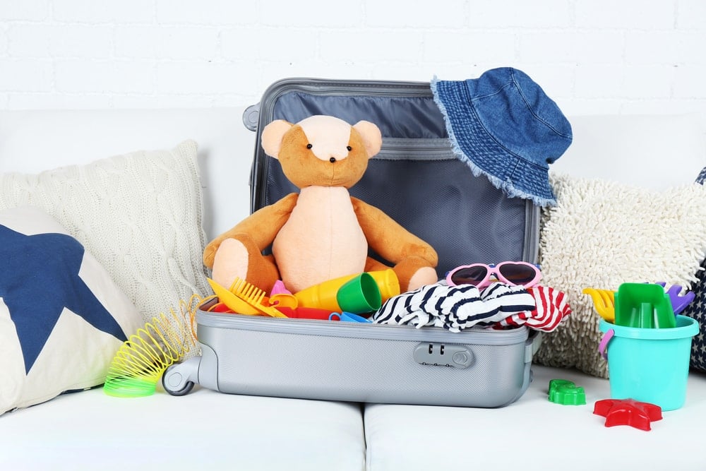 Suitcase filled with toys and children's clothing