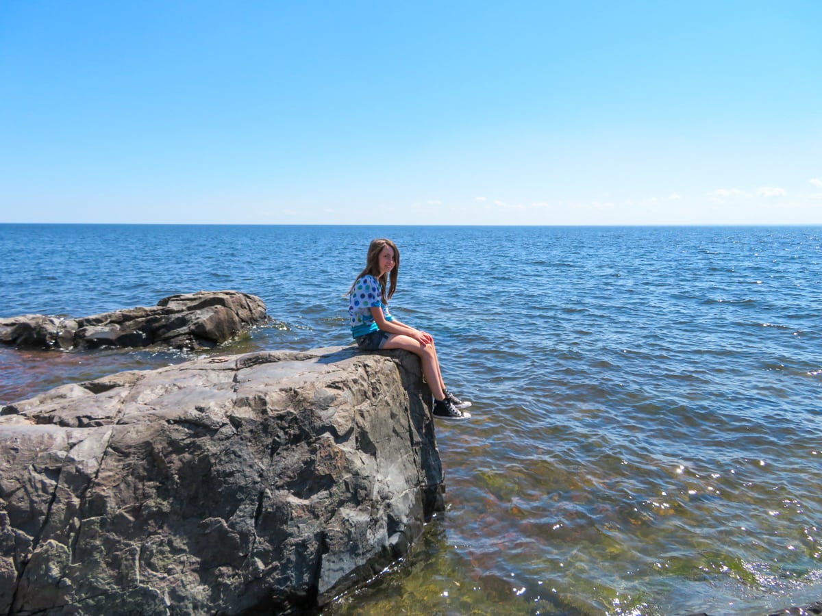 Young girl sitting by Lake Superior in Duluth