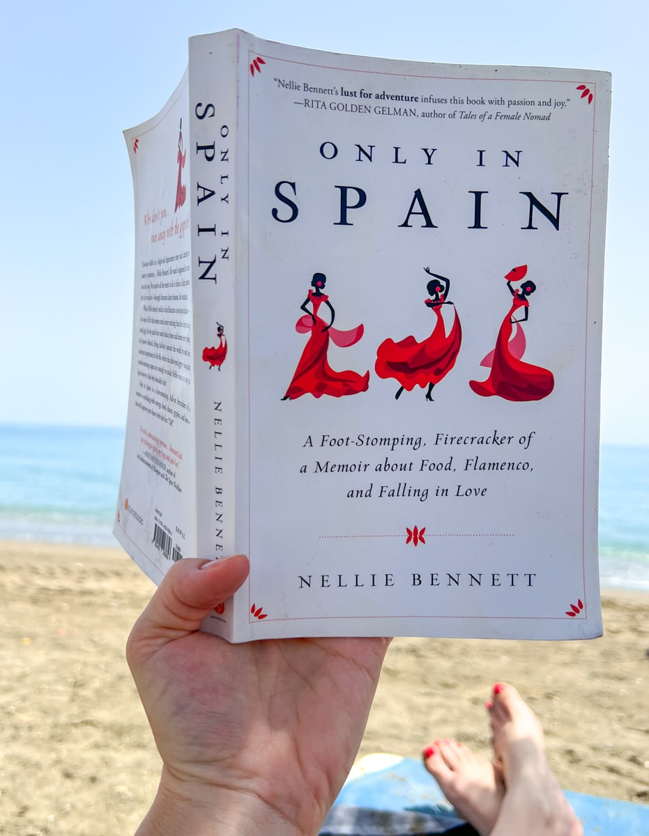Reading "Only in Spain" on the beach in Spain