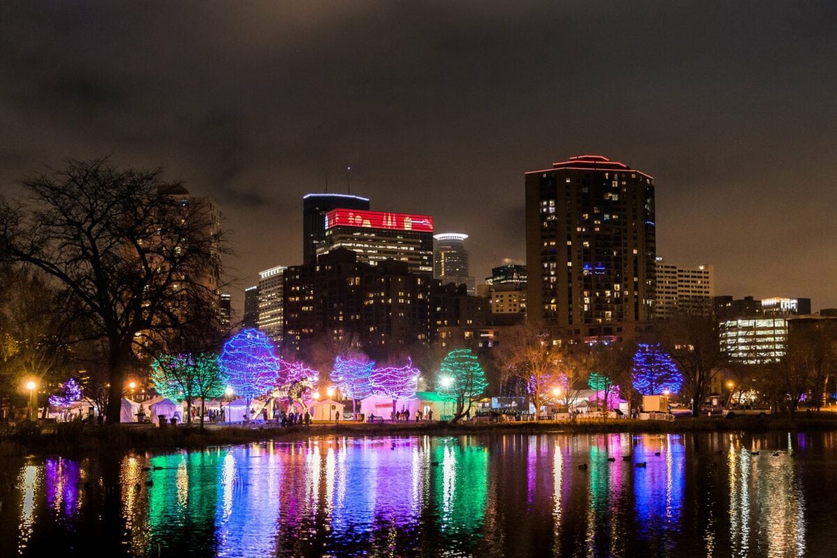 Lights reflected over the water of Loring Pond at the Holidazzle Festival in Minneapolis 
