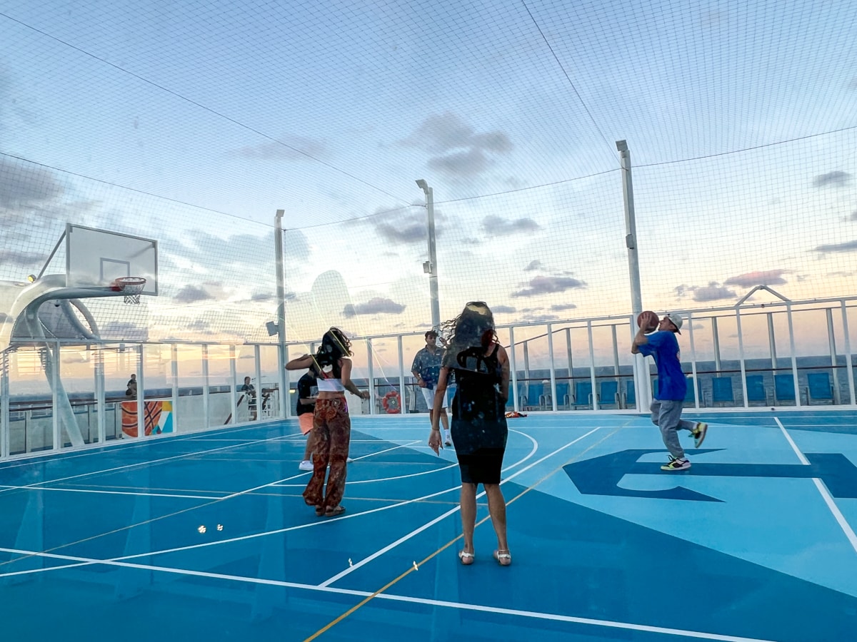 Friends playing basketball together on cruise ship