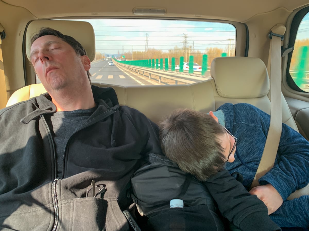 Sleeping dad and son on family road trip