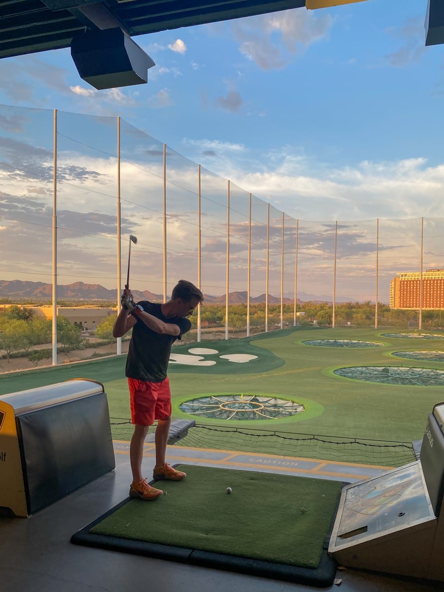Young man hitting the ball at TopGolf Scottsdale 